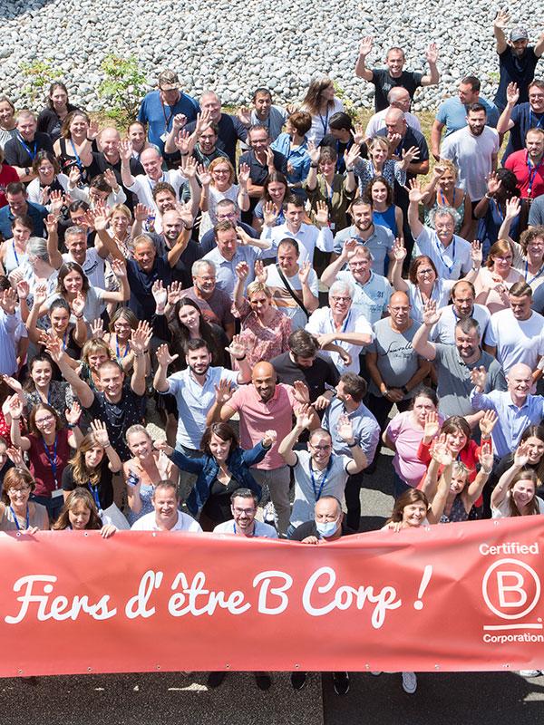 Group of Expanscience employees holding a banner Proud to be B Corp