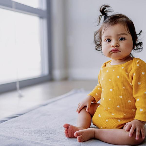 baby with yellow clothing